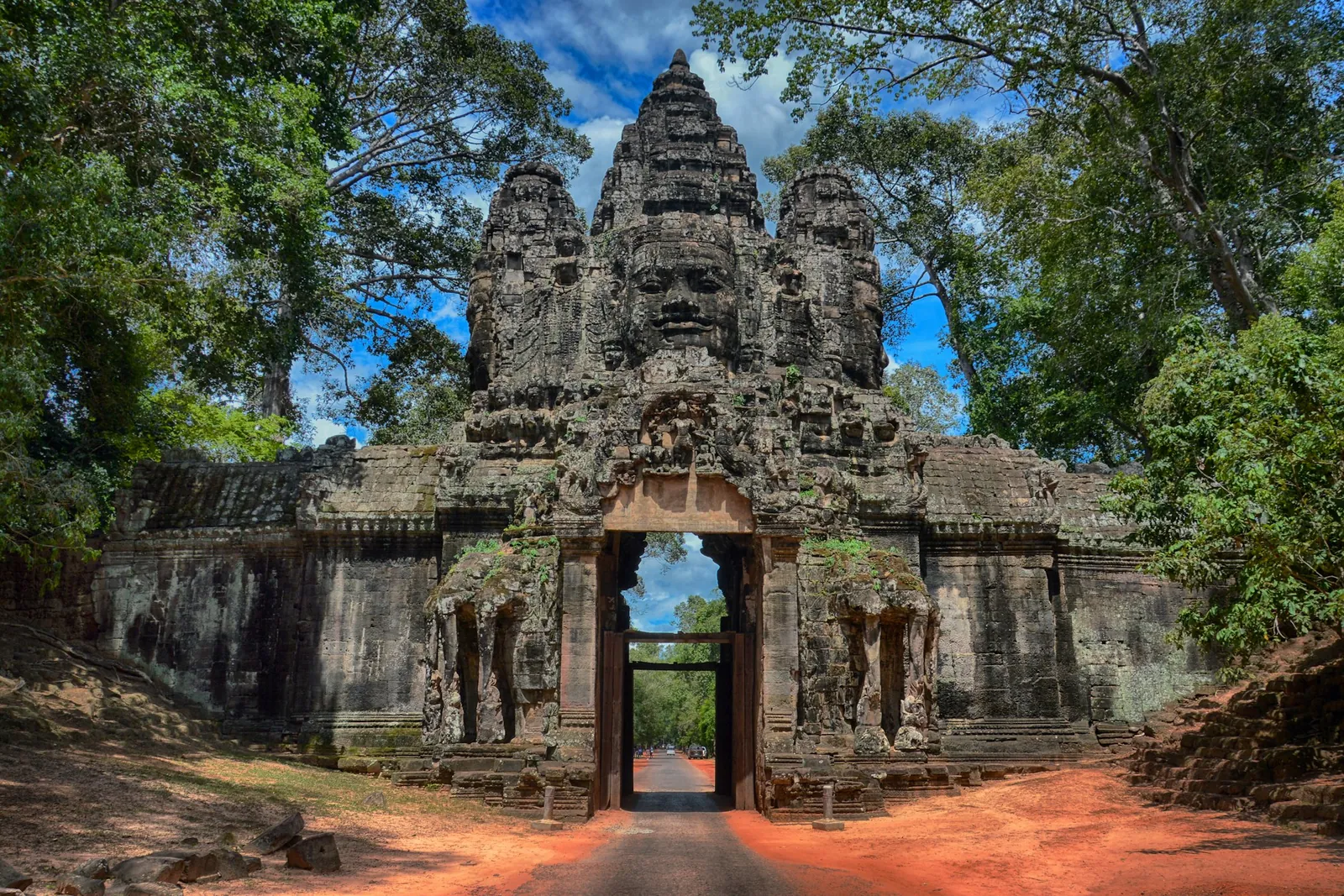 The carved stone faces of the Bayon gate at Angkor Thom, Cambodia.